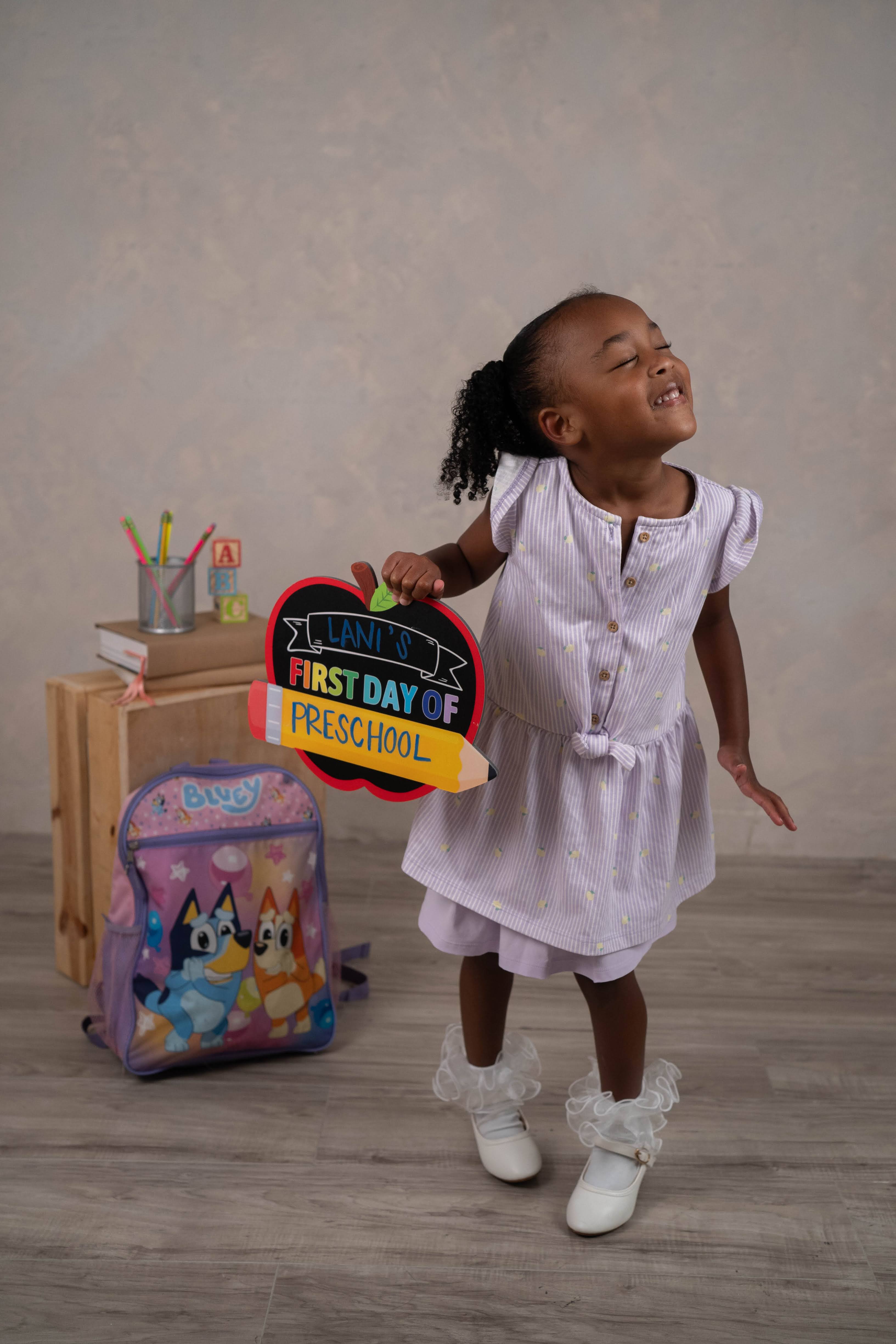 Back-to-school themed portrait with studio school props.