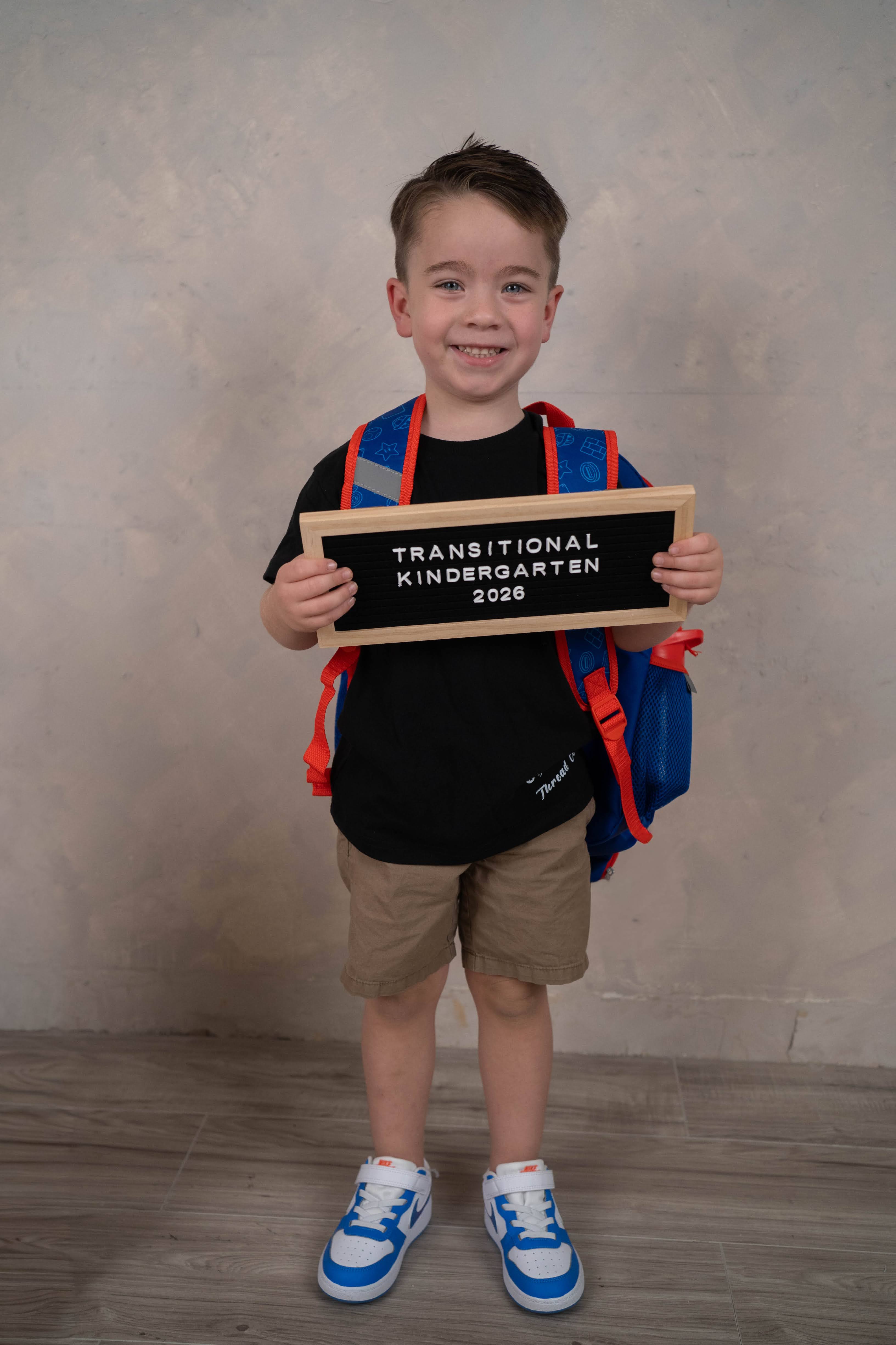 Child smiling during a Back To School Minis portrait session.