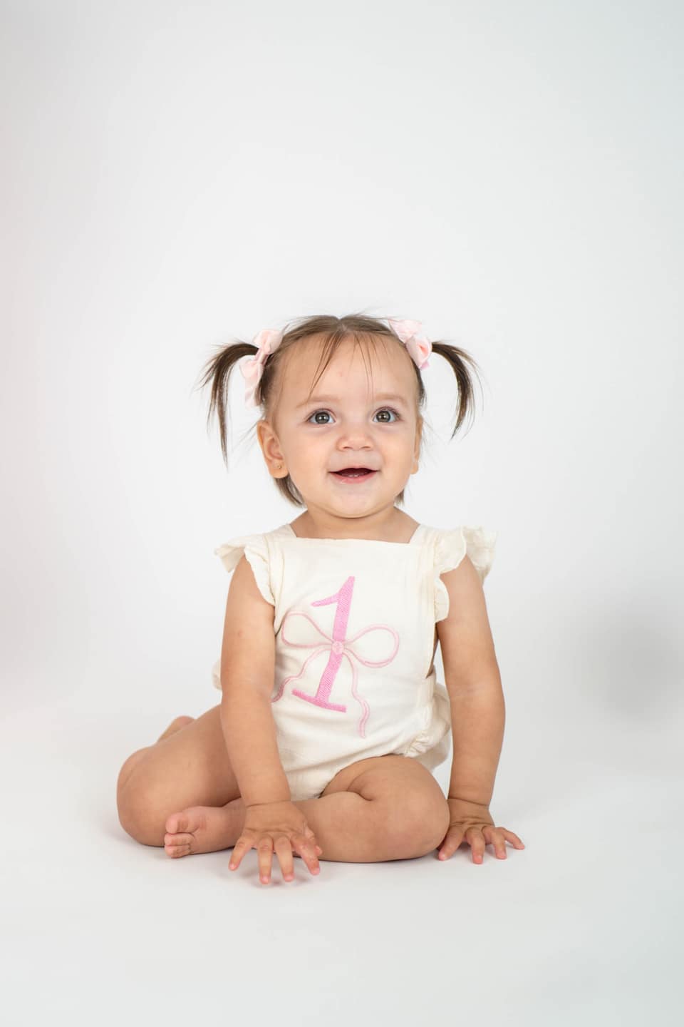 Child playing with cake during a first birthday photo session in Vacaville.